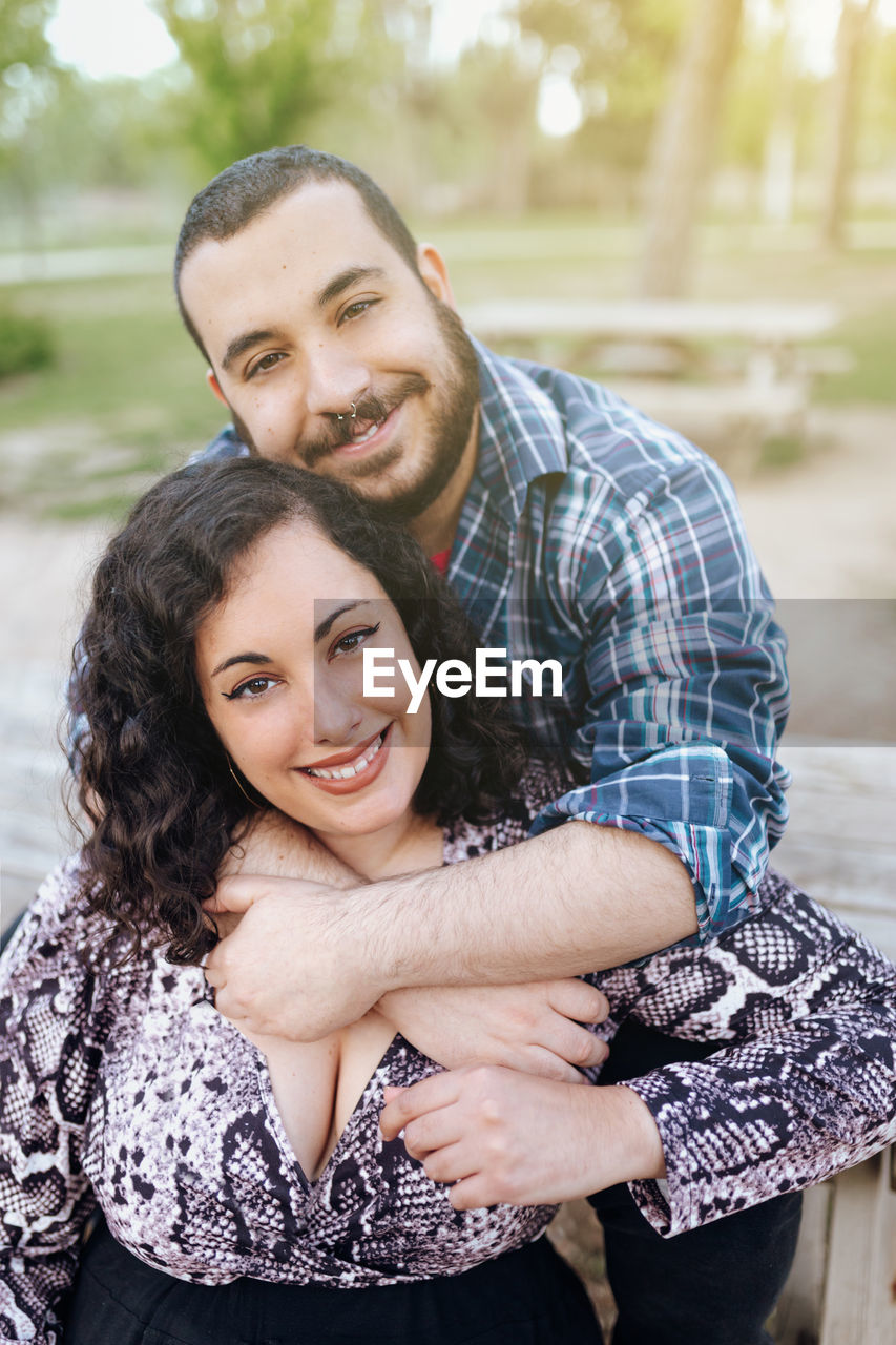 Portrait of a smiling overweight young couple outcdoors. confident and happy people.