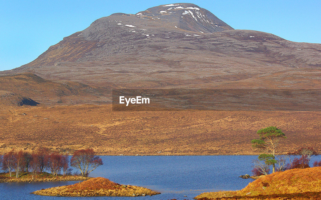 CLOSE UP OF MOUNTAIN AGAINST CLEAR SKY