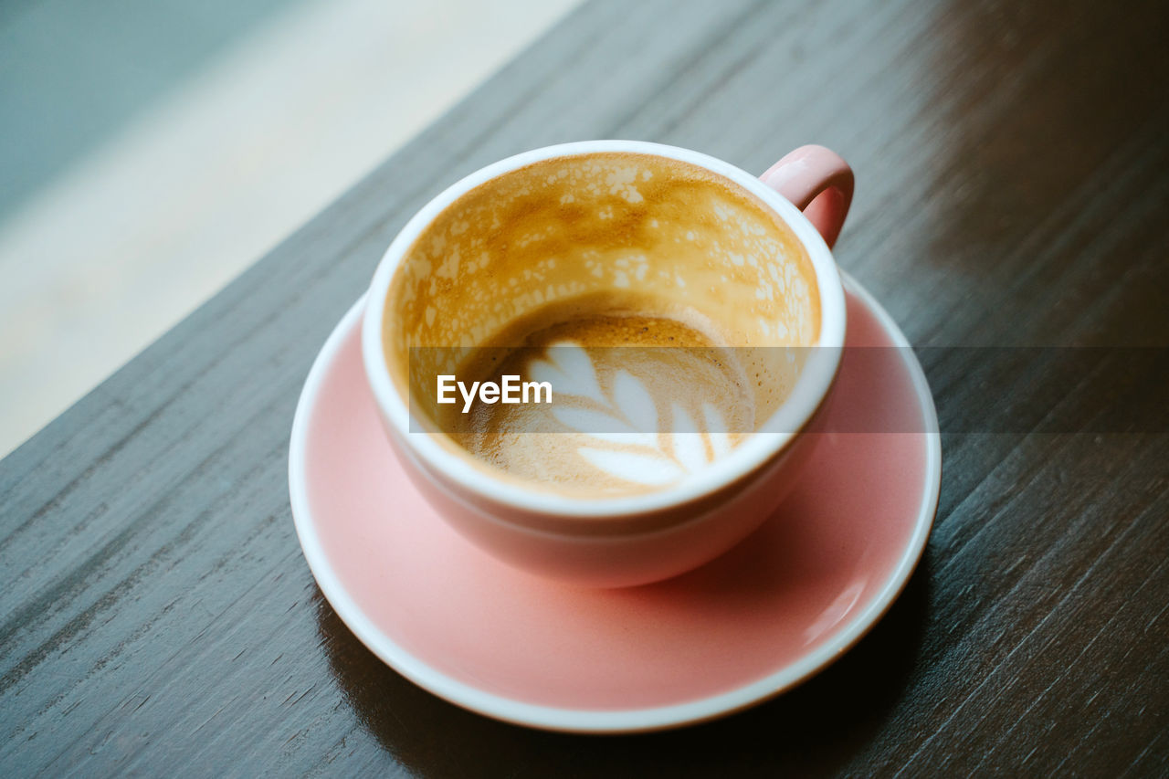 Closeup of a cup of coffee with milk seen from above