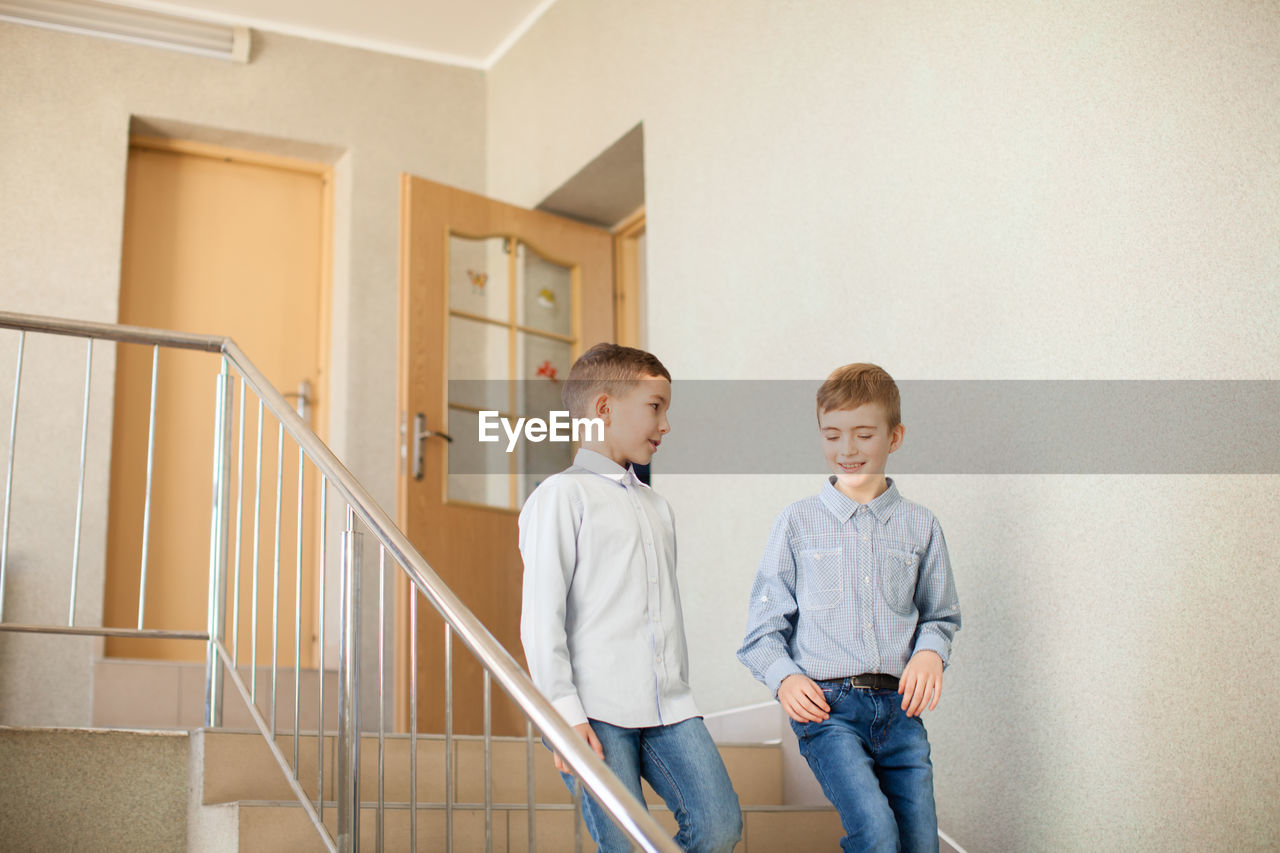 Boy standing on staircase in building