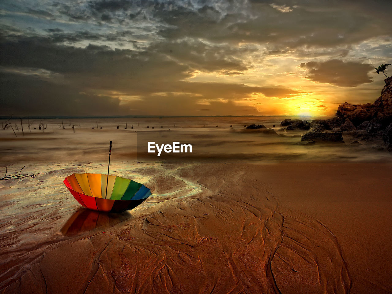 Scenic view of beach against sky during sunset