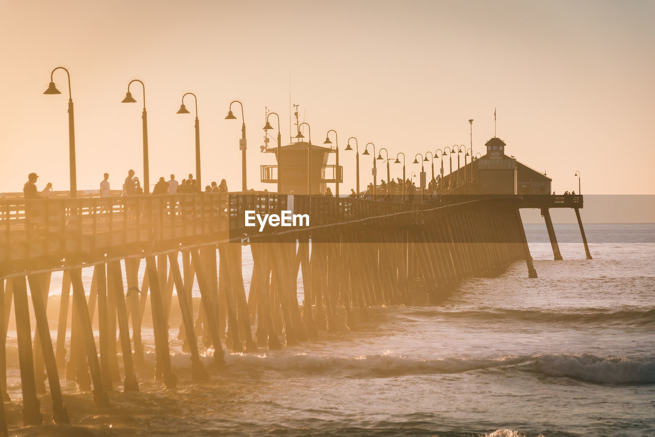 PIER ON SEA AGAINST SKY DURING SUNSET