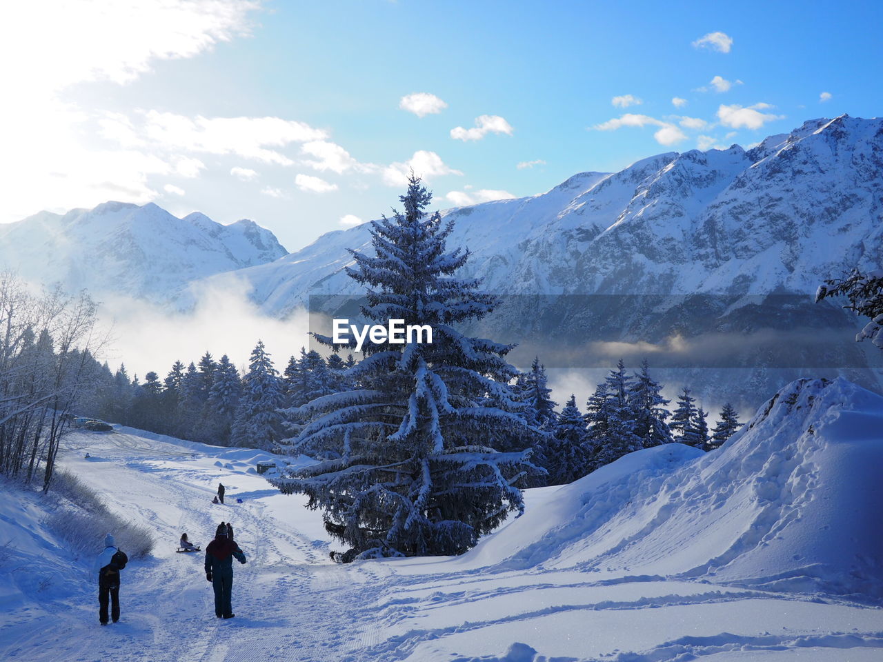 People walking on snow covered landscape