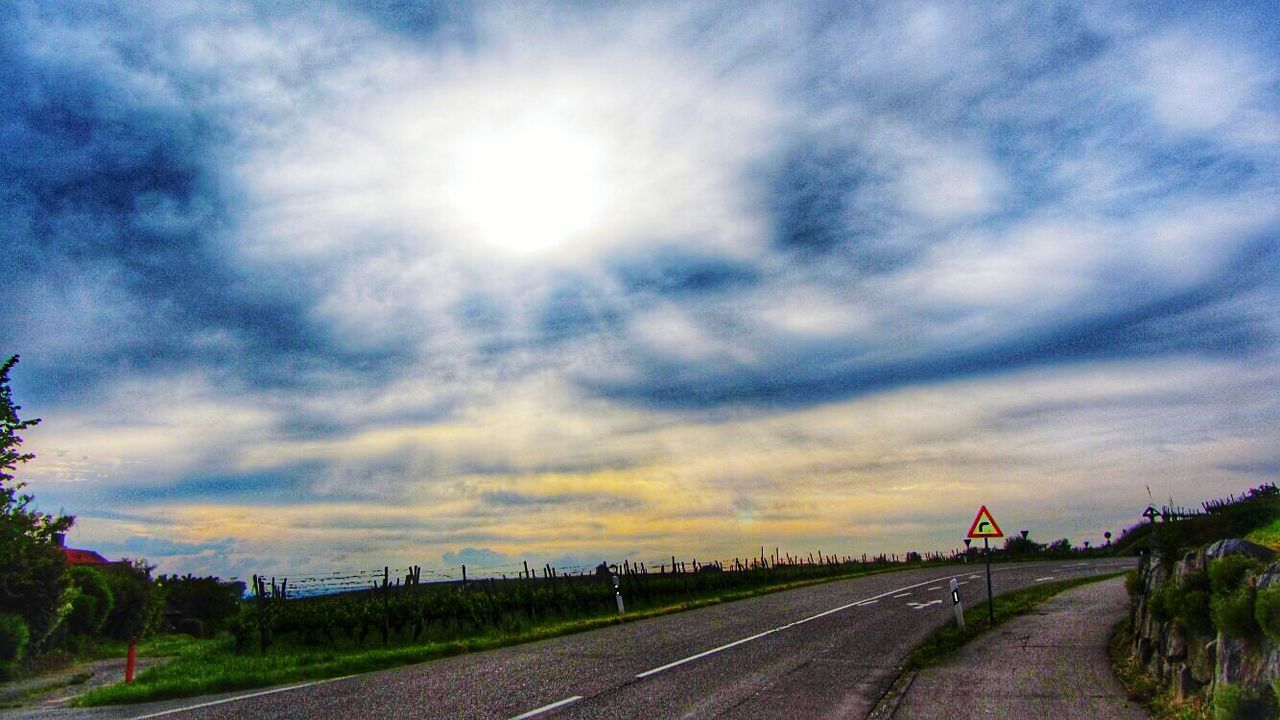 VIEW OF ROAD AGAINST CLOUDY SKY AT SUNSET