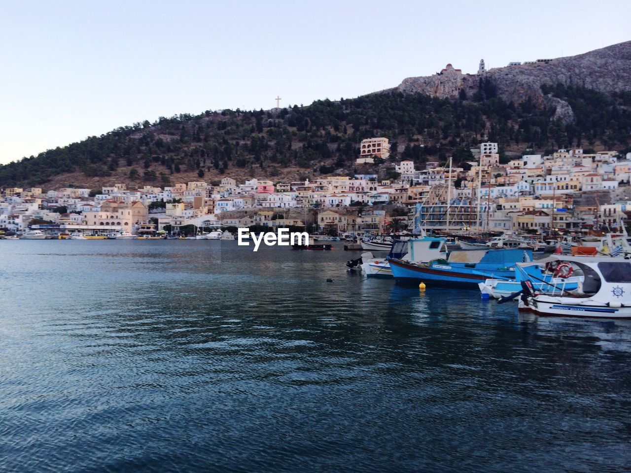 Boats in river with town in background