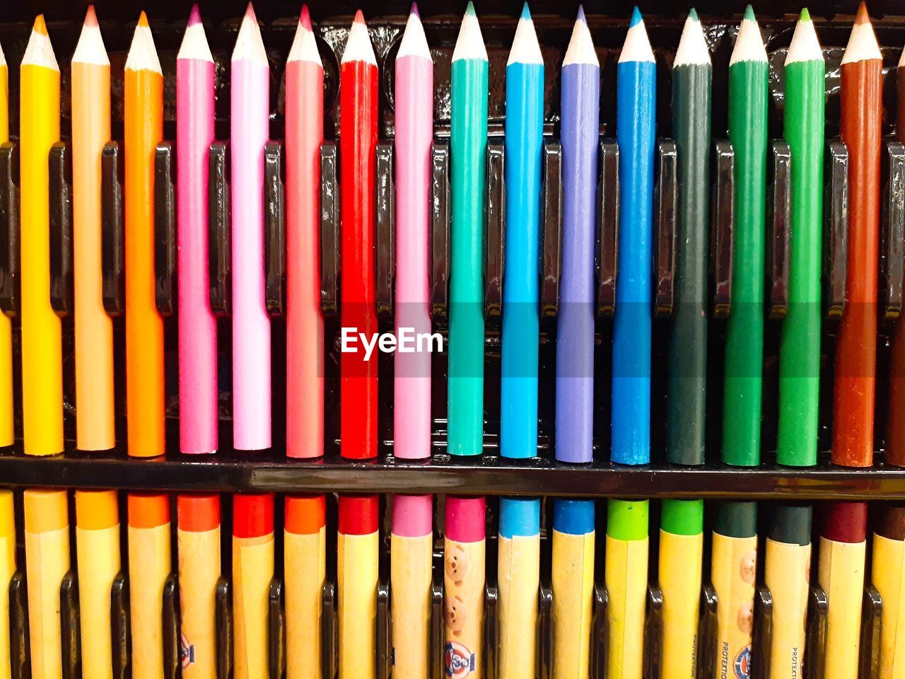 Full frame shot of colored pencils in container