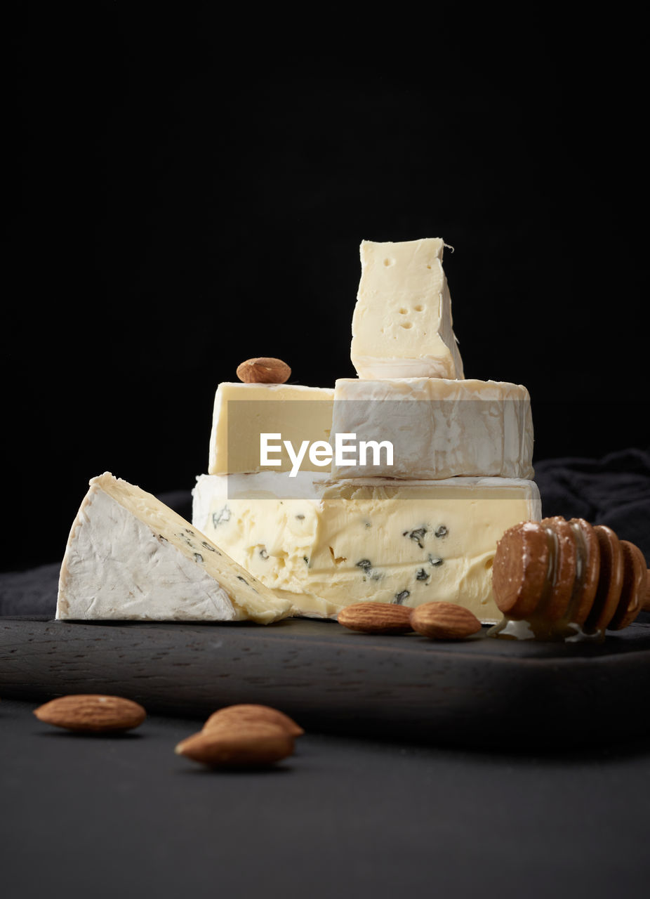 Brie and bergader blue cheese on a brown wooden board, delicious snack