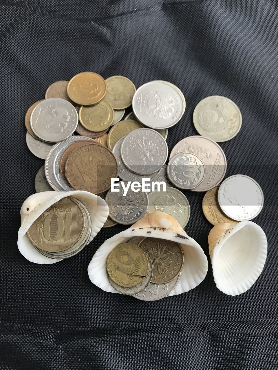 HIGH ANGLE VIEW OF COINS IN CONTAINER