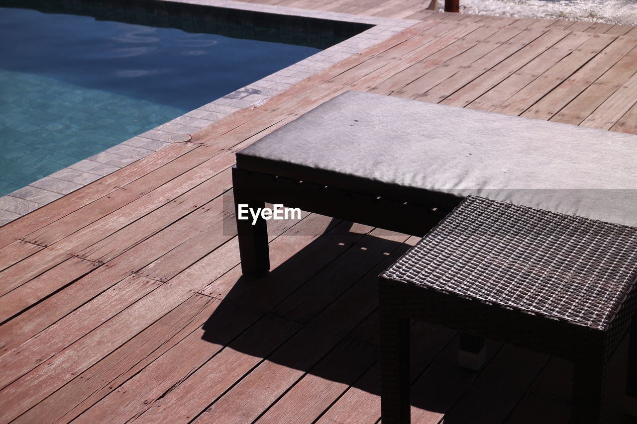 wood, water, floor, nature, swimming pool, deck, seat, no people, high angle view, sunlight, architecture, day, relaxation, outdoors, chair, poolside, outdoor structure, flooring, summer, pier, shadow, table, roof, furniture, bench, built structure, absence, floorboard, lake