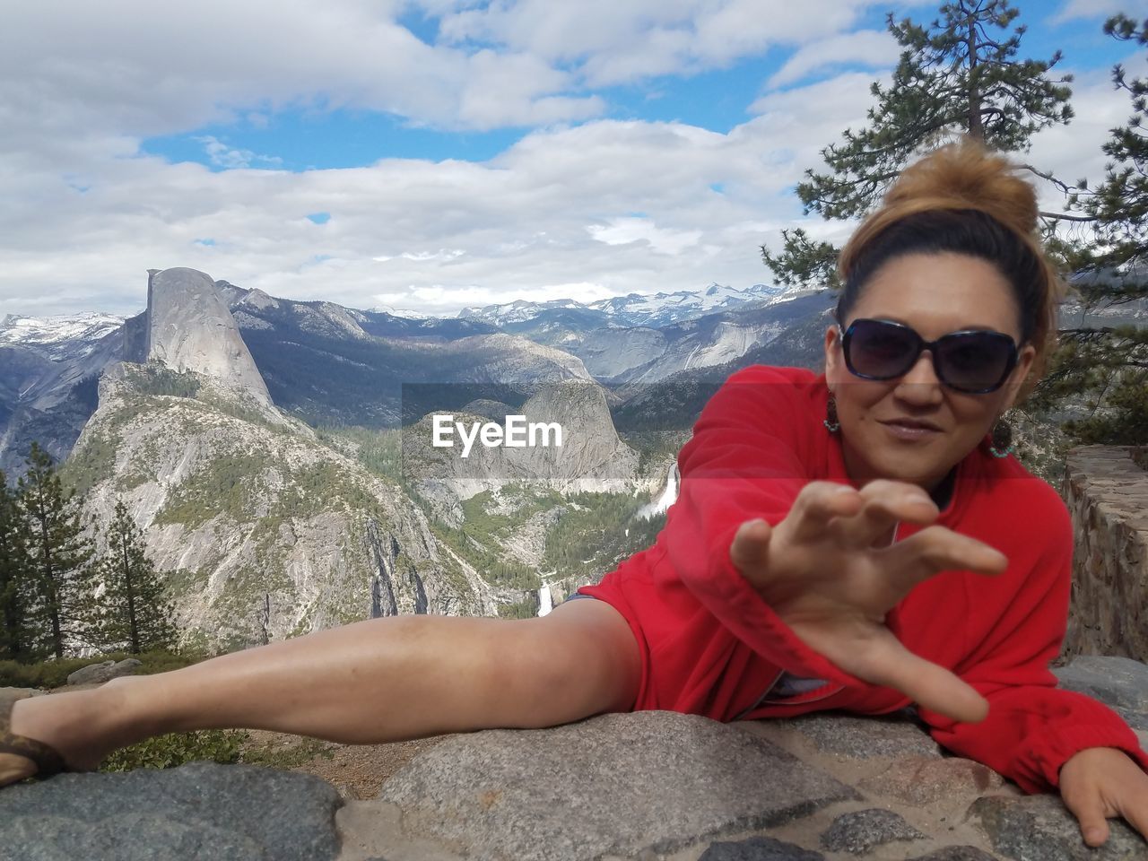 Portrait of smiling woman climbing rock at yosemite valley against half dome