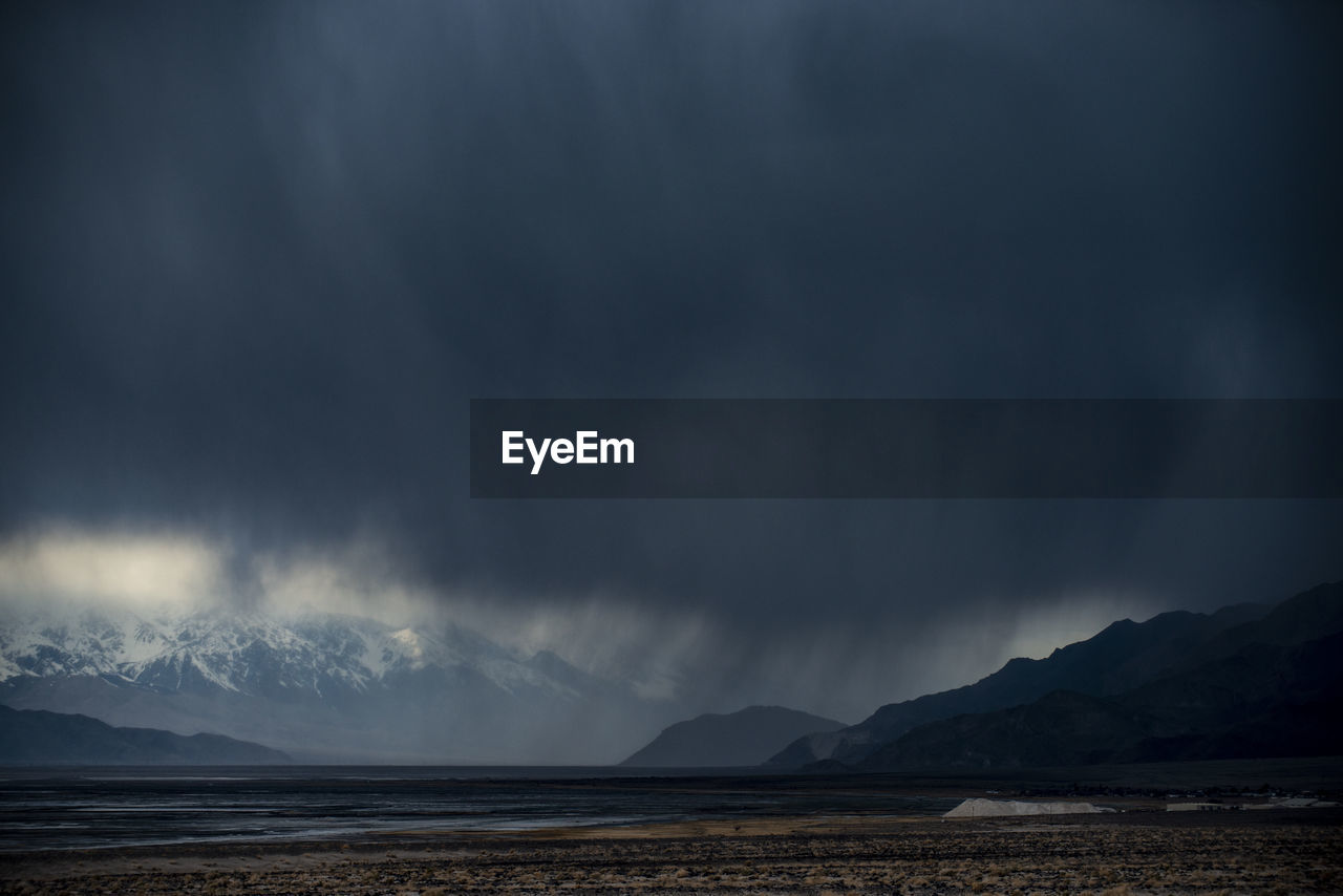 A storm passes through the badwater basin salt flats desert in d