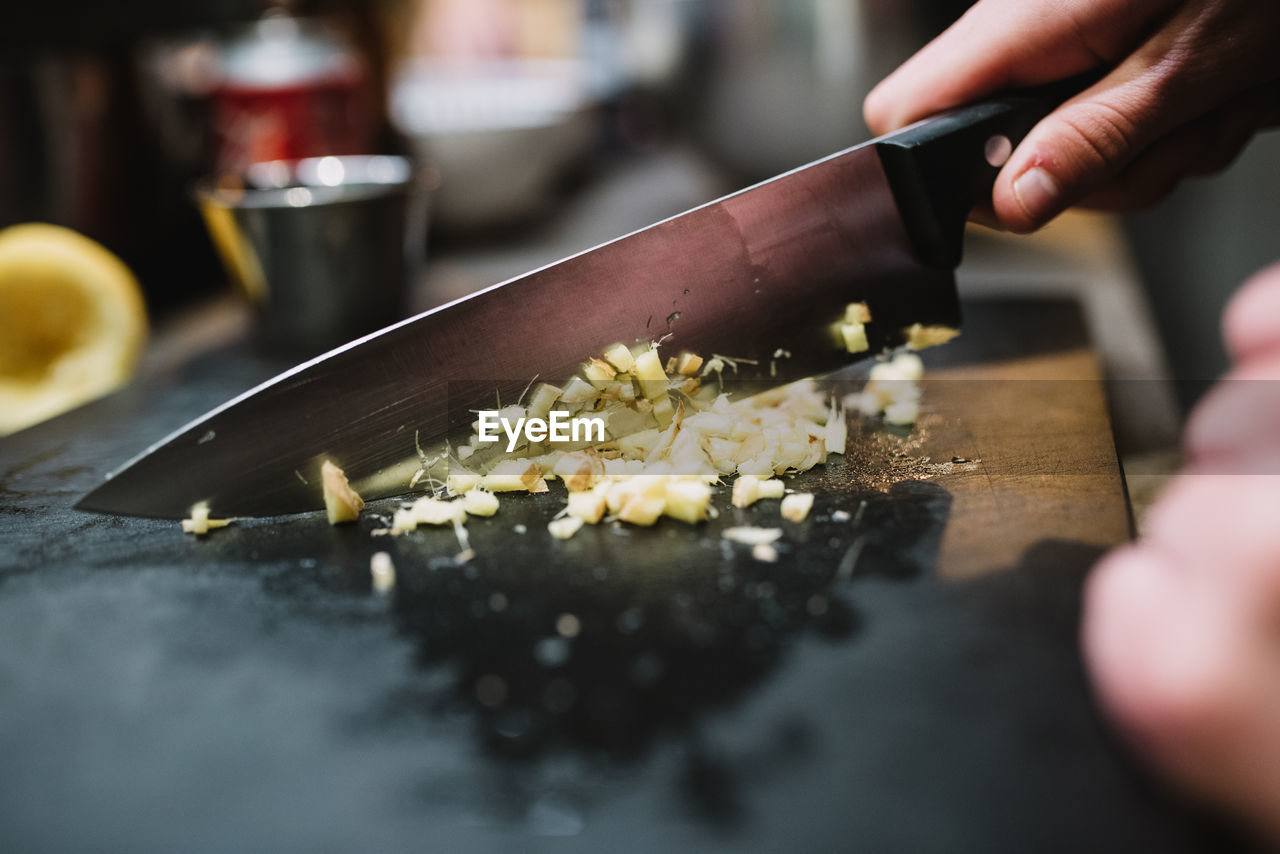 Closeup anonymous person chopping fresh ingredient with sharp knife during cooking course in restaurant kitchen in navarre, spain person