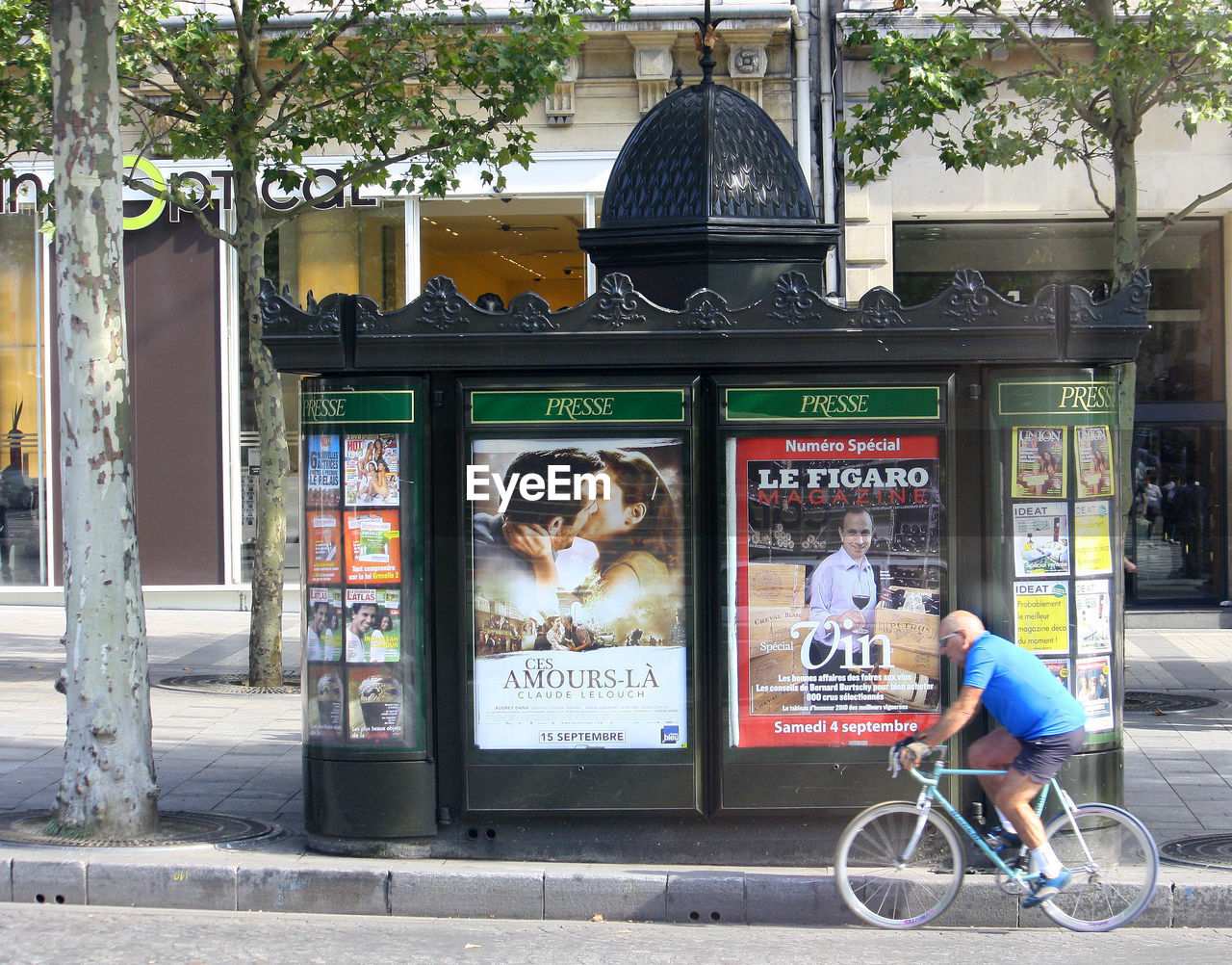 MAN WITH SHOPPING CART IN BACKGROUND