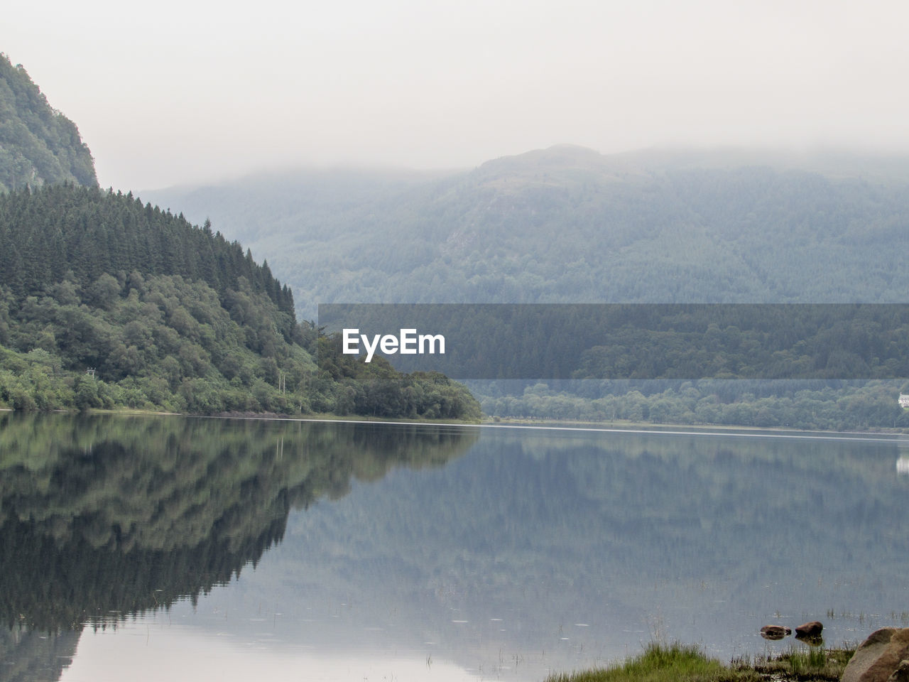 SCENIC VIEW OF LAKE WITH MOUNTAINS IN BACKGROUND