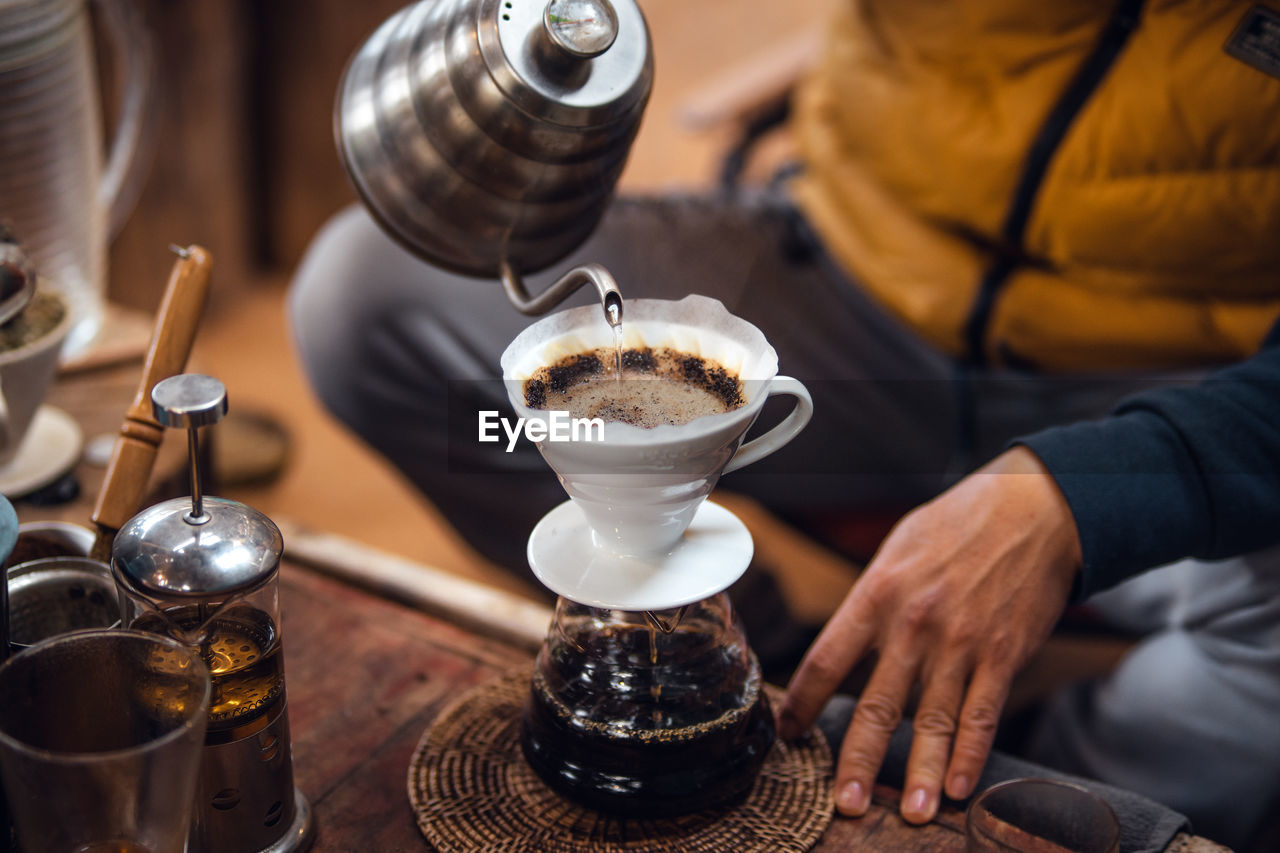 cropped hand of person holding coffee