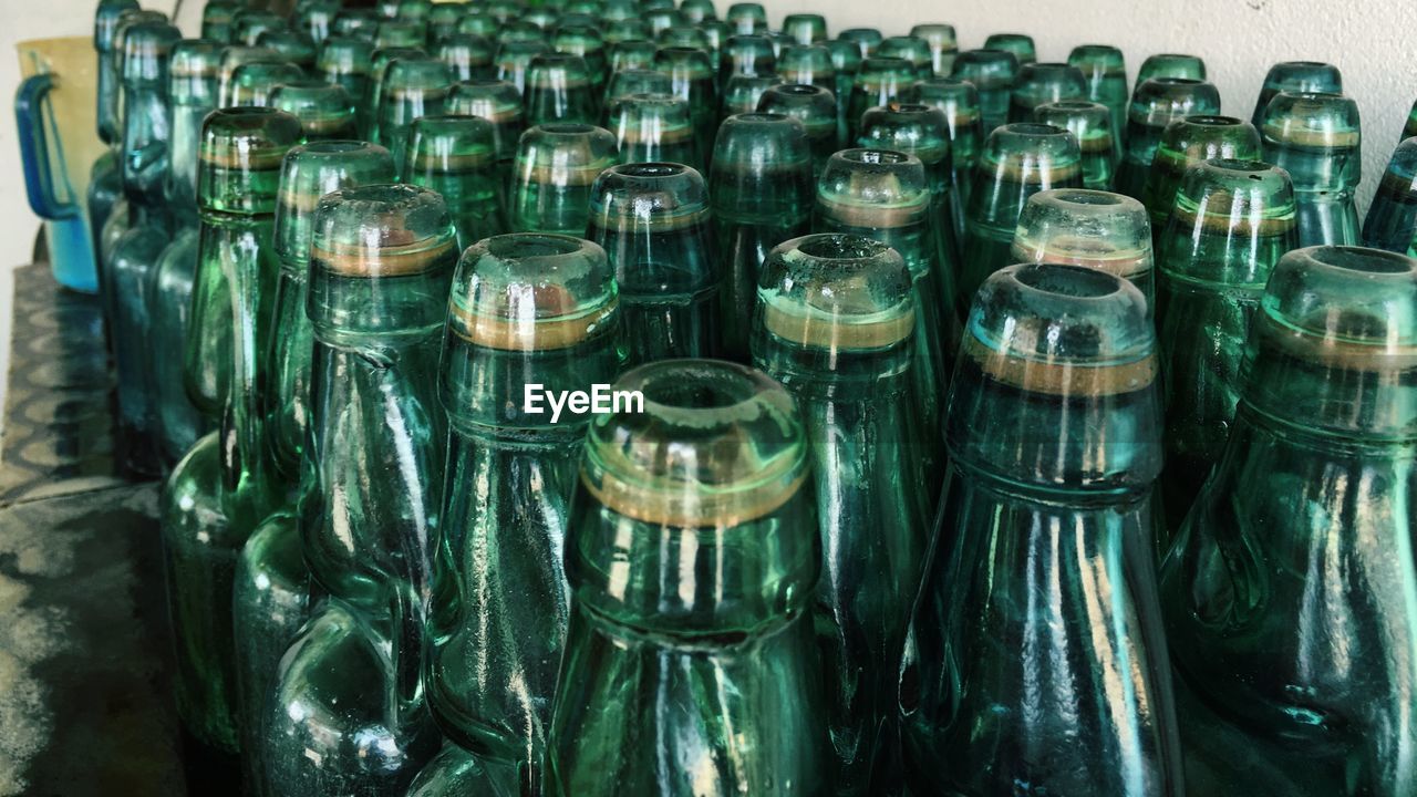 FULL FRAME SHOT OF GLASS WITH BOTTLES