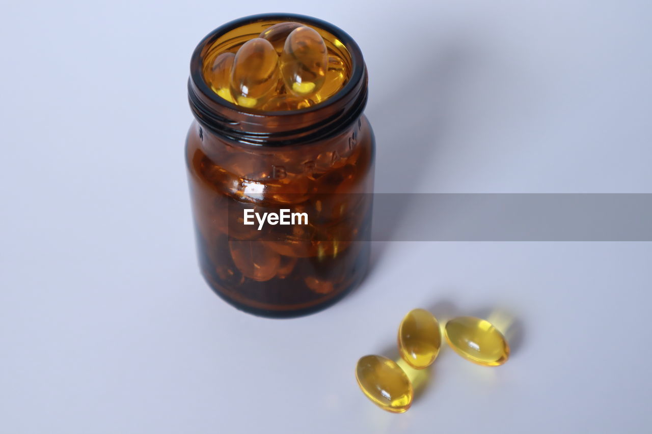 CLOSE-UP OF GLASS JAR ON TABLE