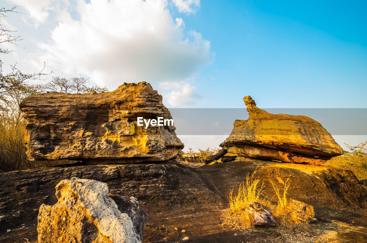 ROCK FORMATIONS AGAINST CLOUDY SKY