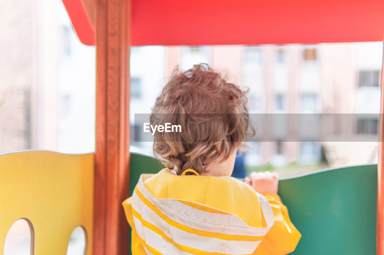 Portrait of boy with yellow umbrella