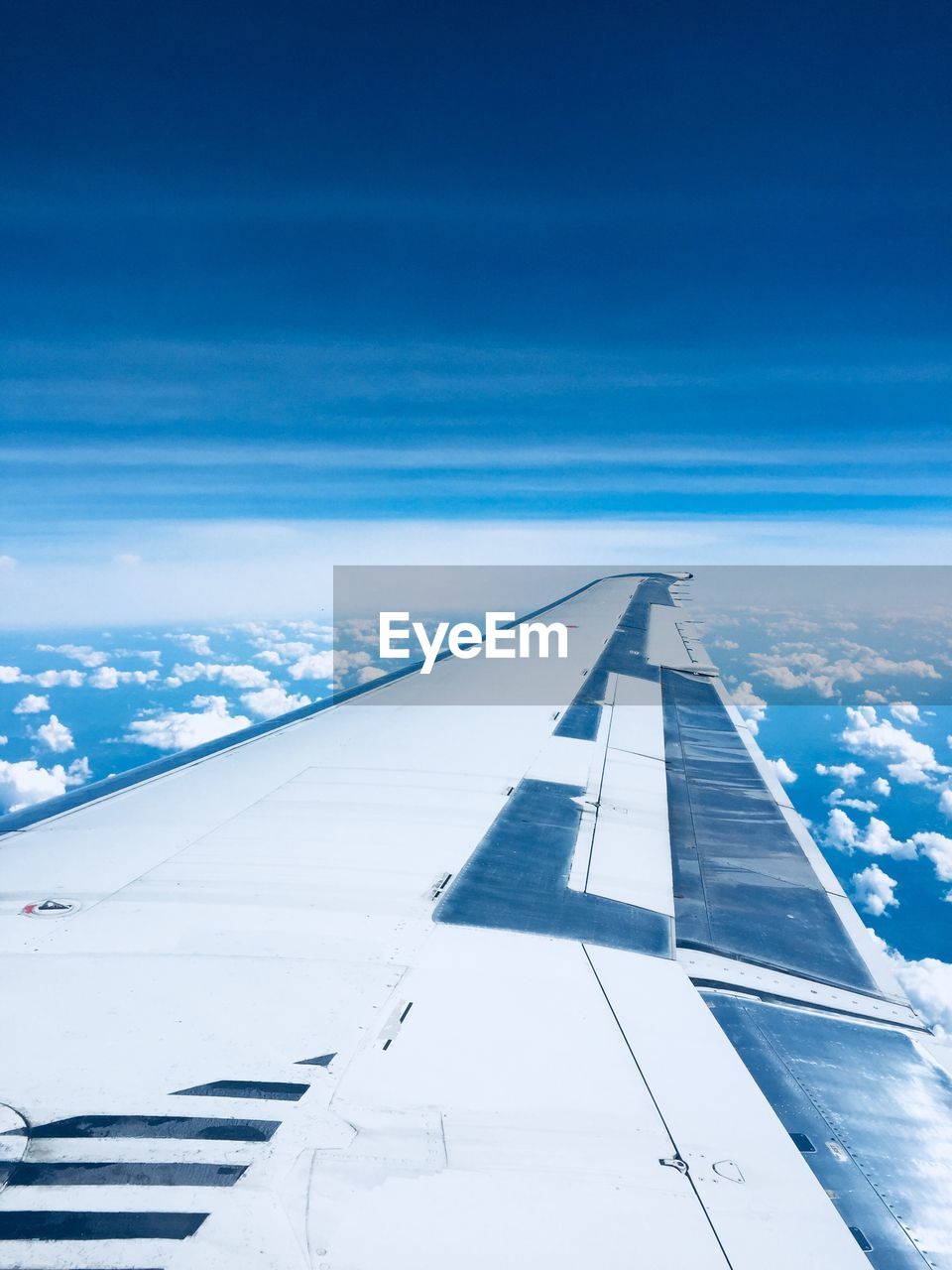 Aircraft wing against cloudy sky