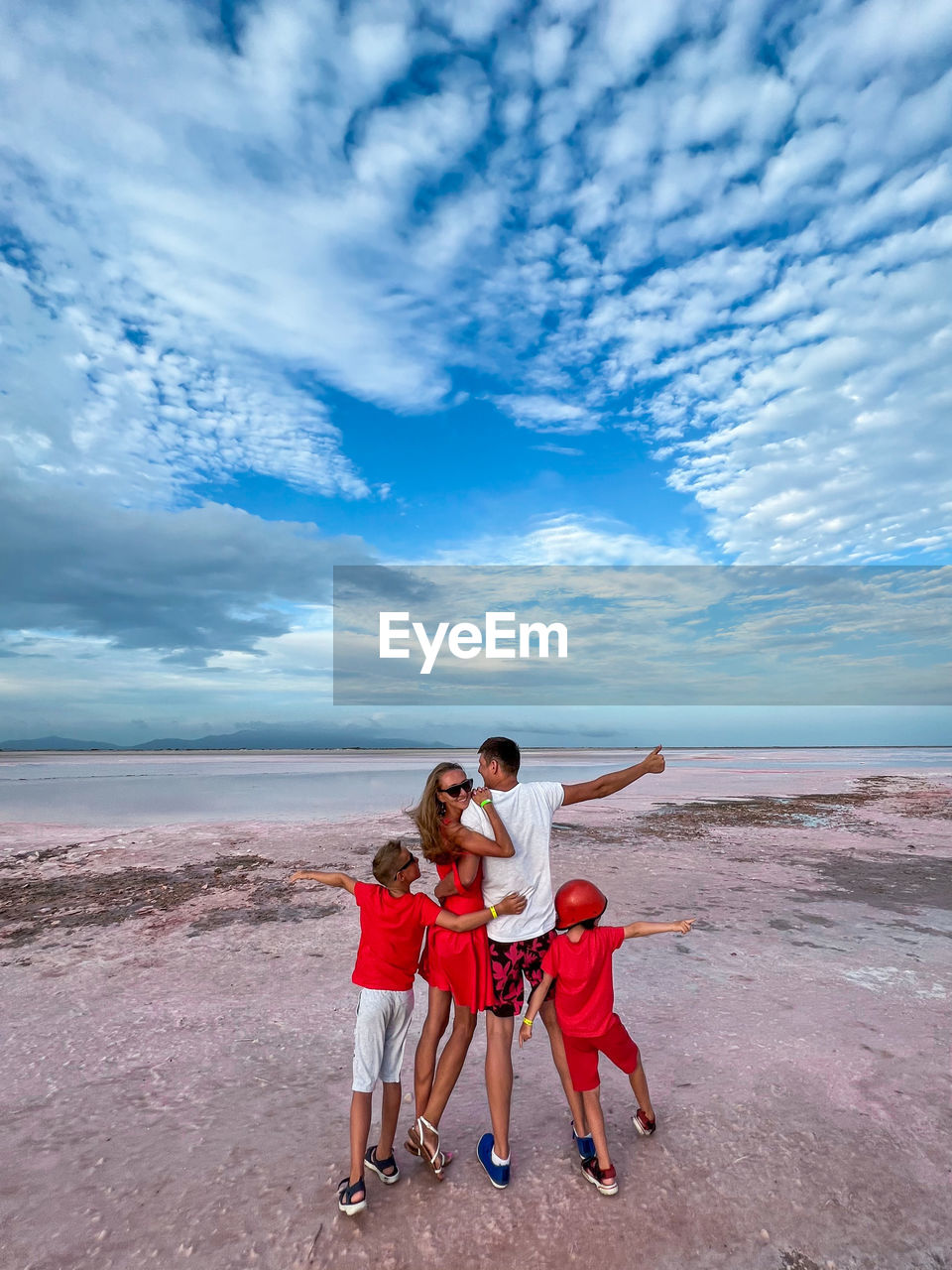 Family on a pink salt lake in the island of coche in the caribbean in venezuela