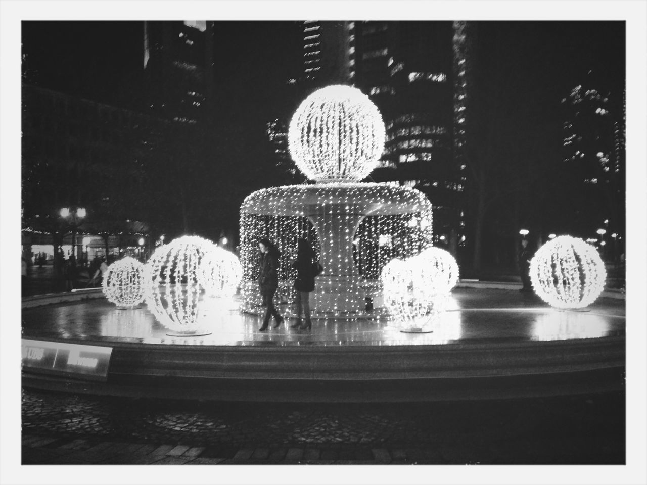 VIEW OF ILLUMINATED LIGHTS AT NIGHT