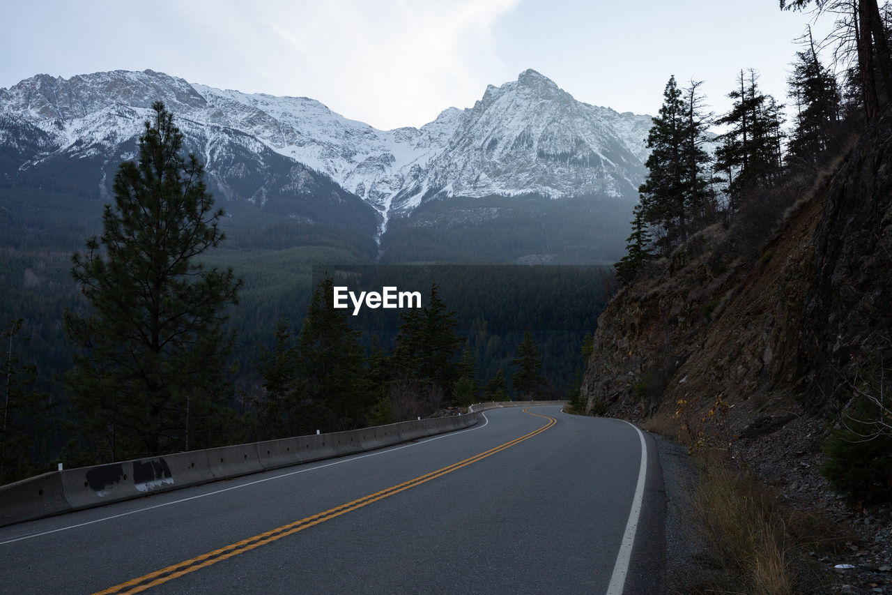 ROAD LEADING TOWARDS SNOWCAPPED MOUNTAINS