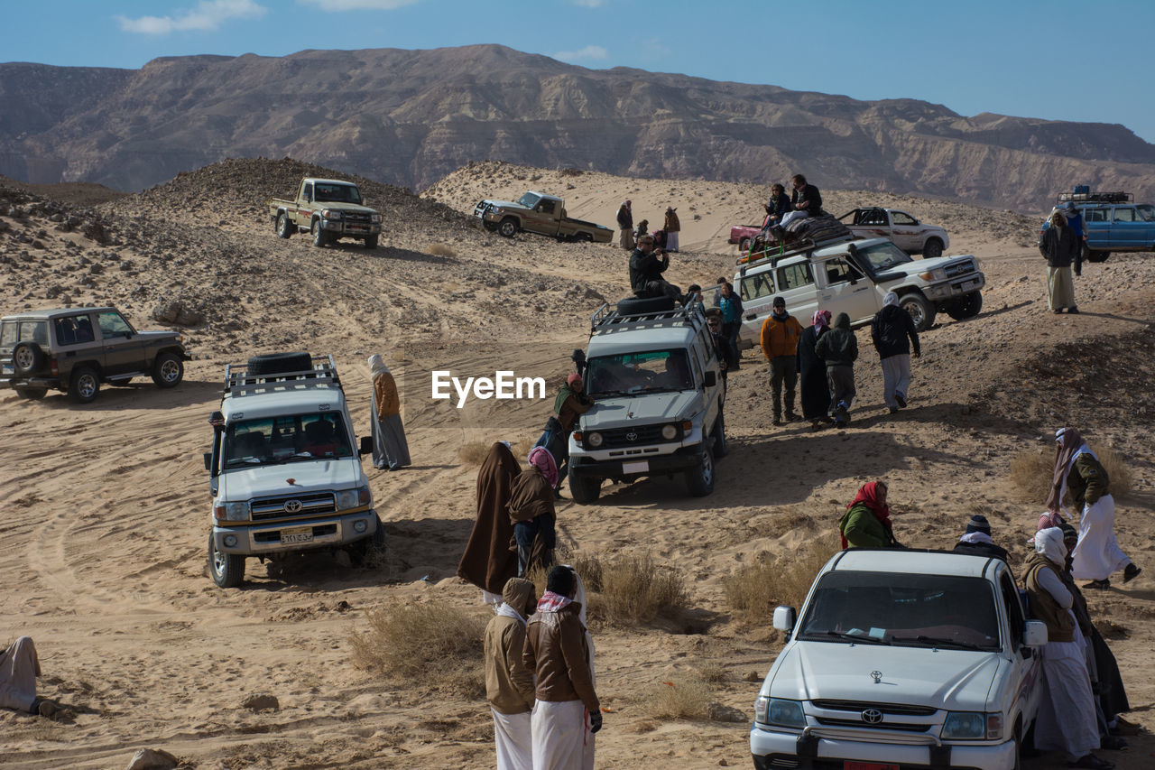 PANORAMIC VIEW OF PEOPLE ON DESERT ROAD