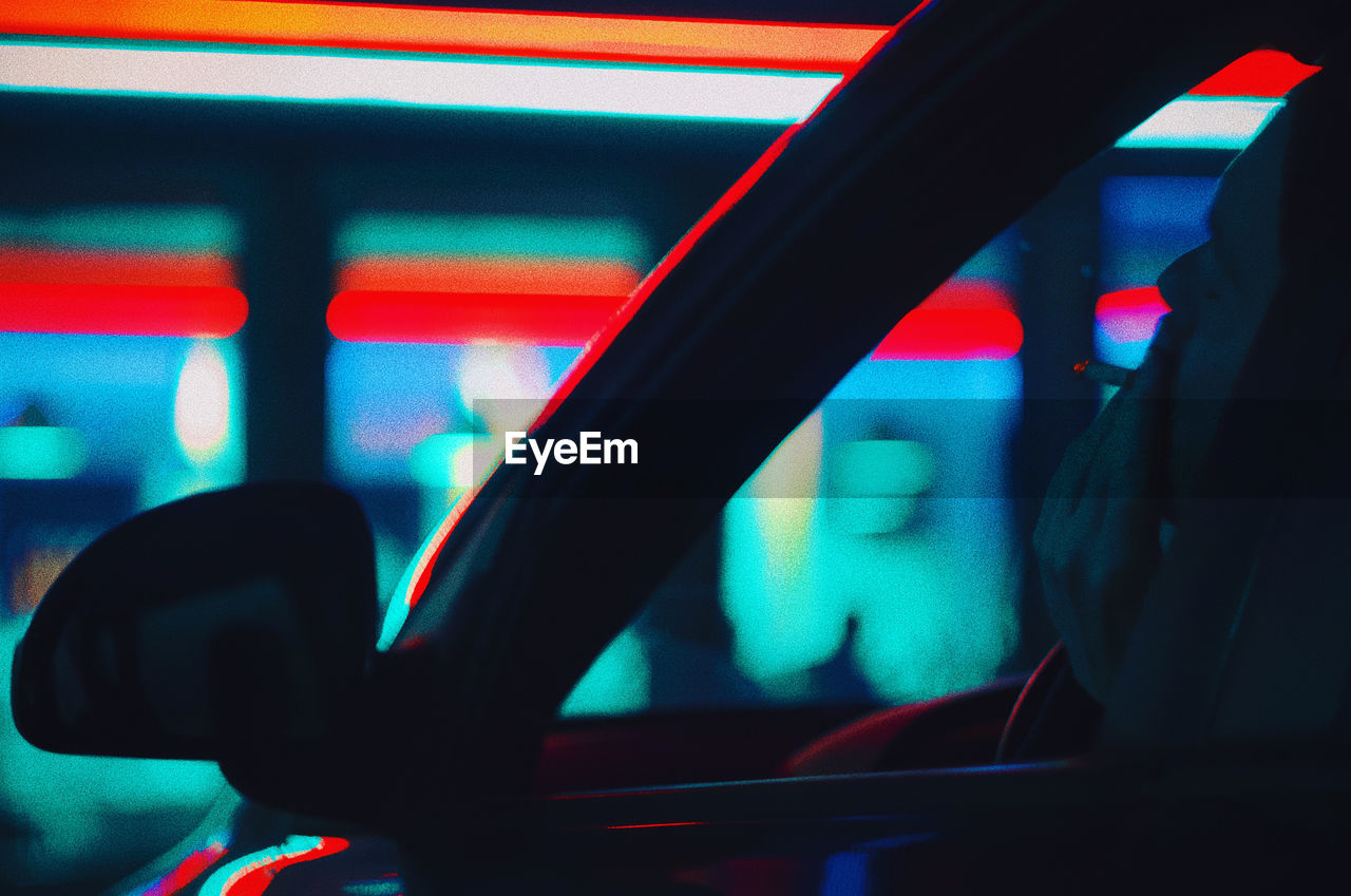 Close-up of man smoking while sitting in car