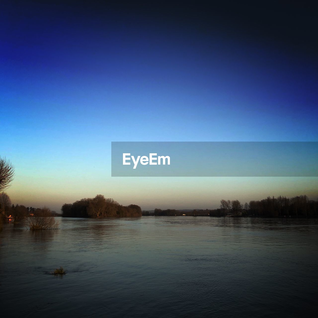 VIEW OF LAKE AGAINST CLEAR BLUE SKY