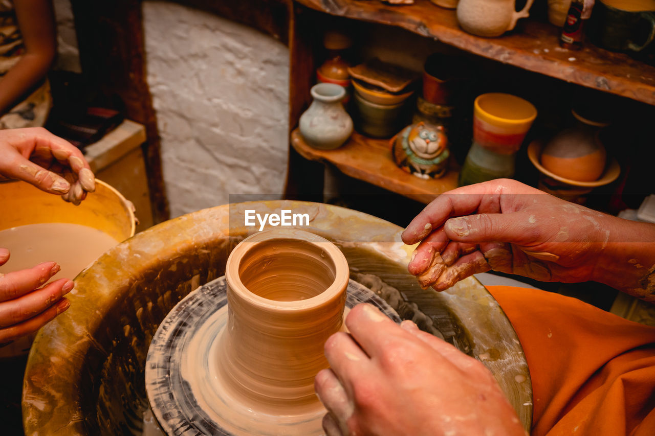 cropped image of man working on pottery wheel