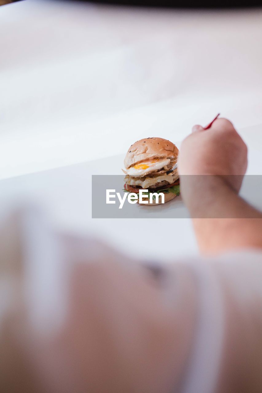 Close-up of hand holding a burger