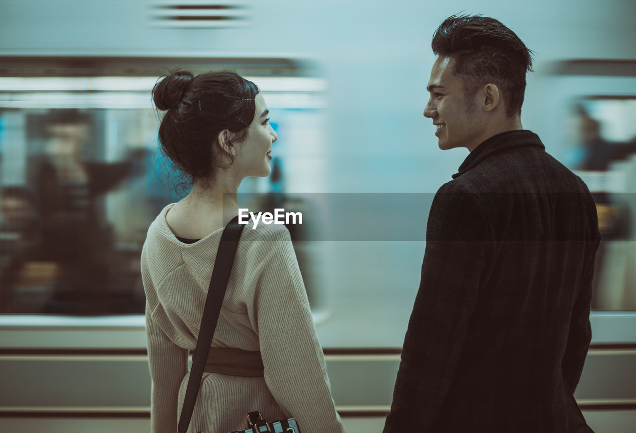 Couple standing on subway station