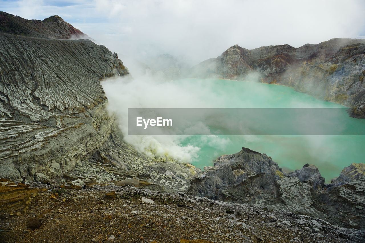 The view of green acid lake from top of mount ijen.