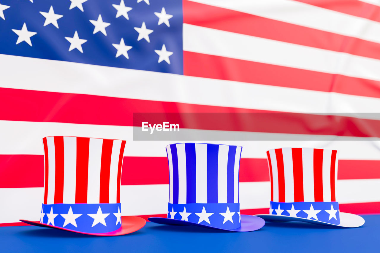 CLOSE-UP OF FLAGS AGAINST BLUE COLORED BACKGROUND