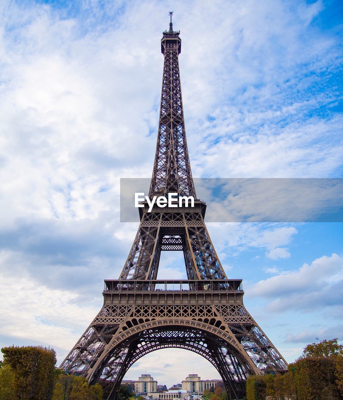 Eiffel tower against cloudy sky