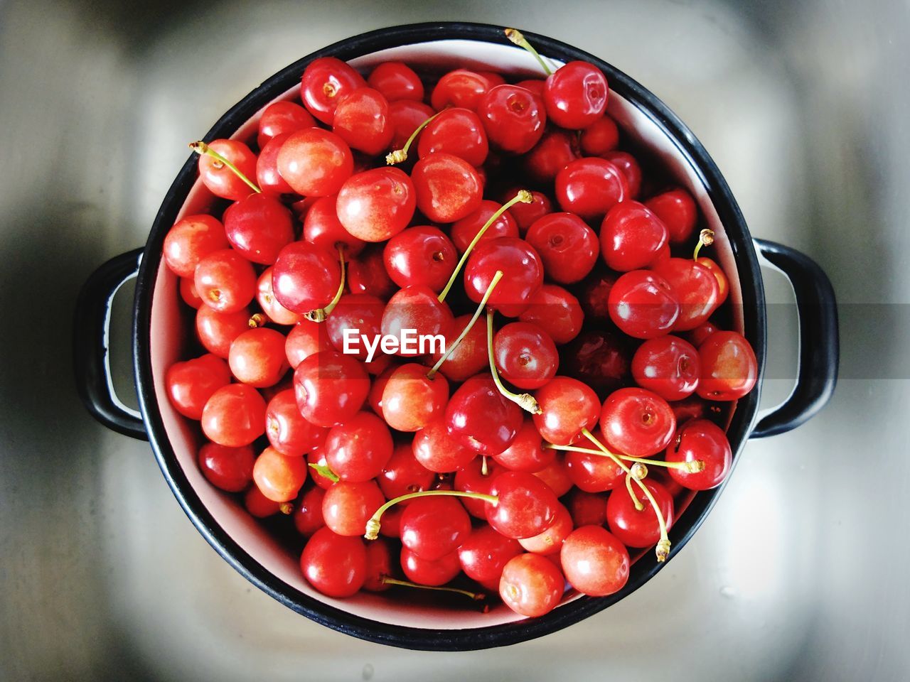 Directly above shot of cherries in cooking pan on table