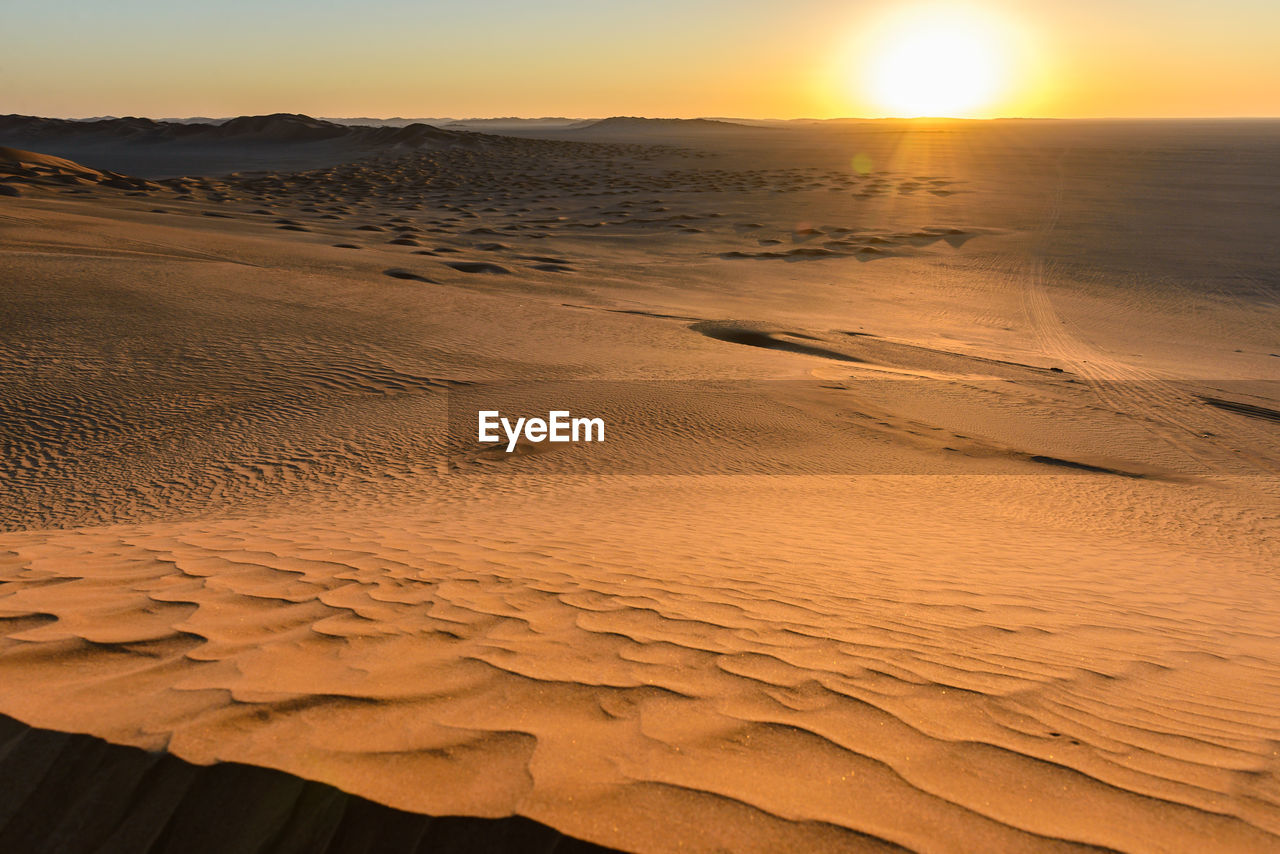 Scenic view of beach against sky during sunset