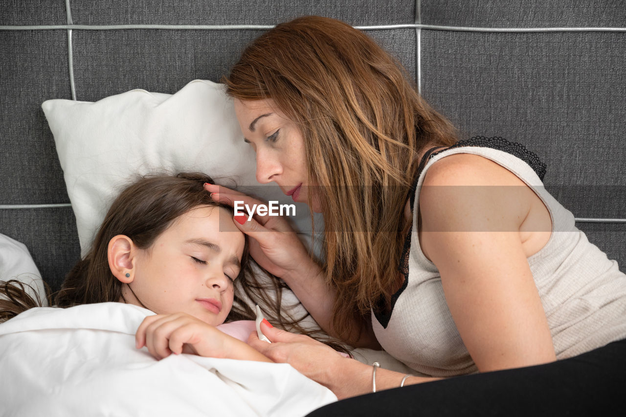 portrait of young woman sleeping on bed