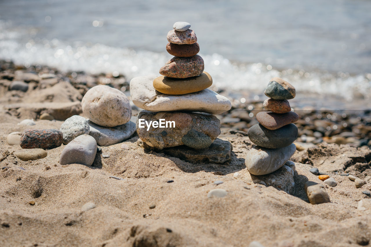 STACK OF STONES ON SAND
