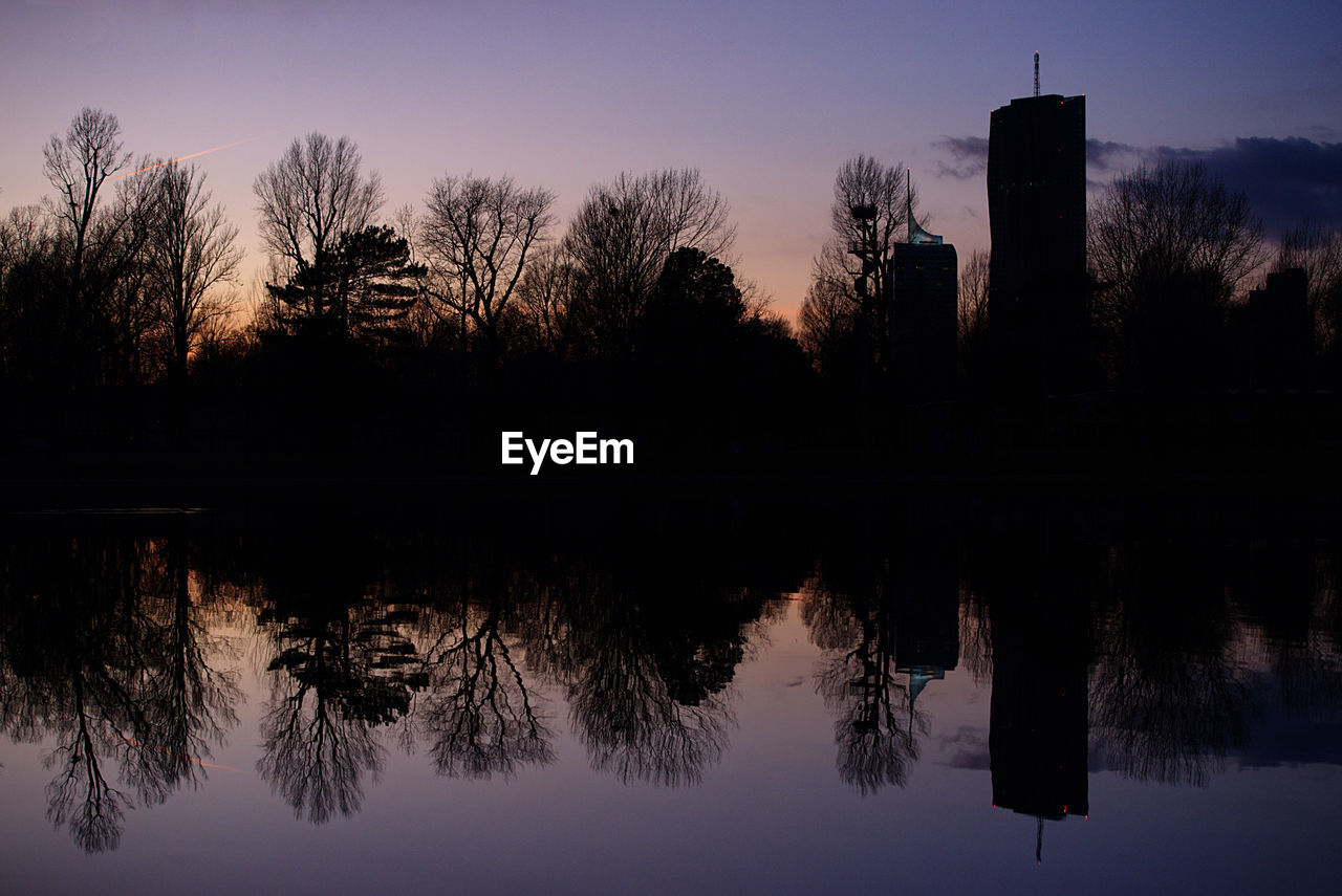 REFLECTION OF TREES IN LAKE