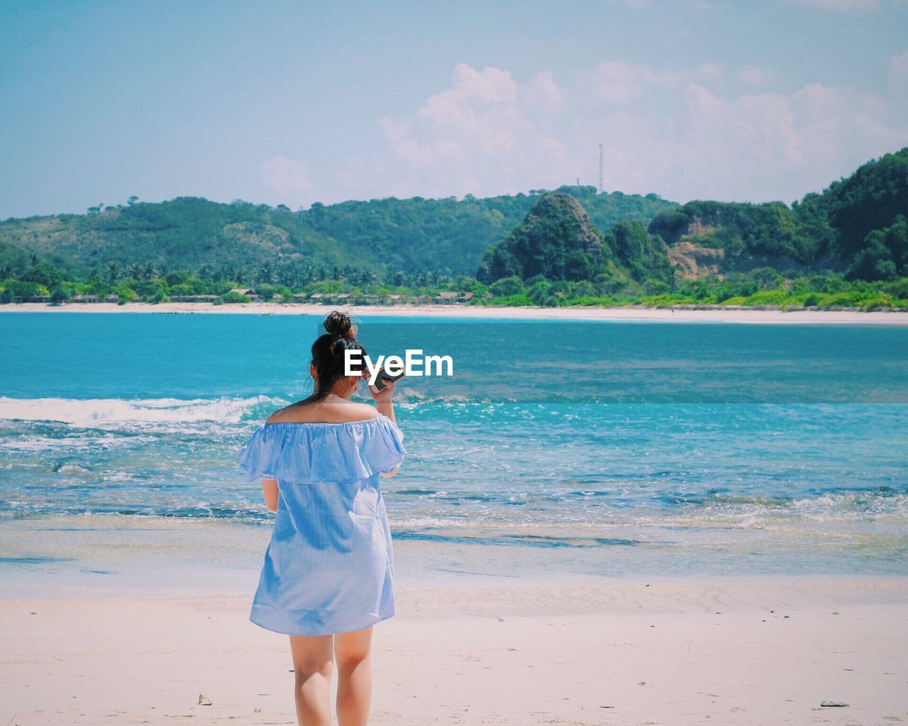 Woman standing on calm beach