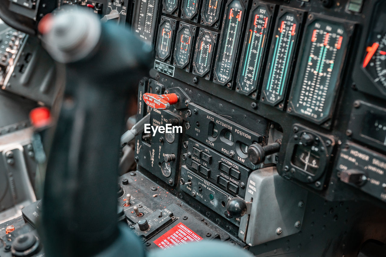 CLOSE-UP OF AIRPLANE SEEN THROUGH MACHINE IN AIRPORT