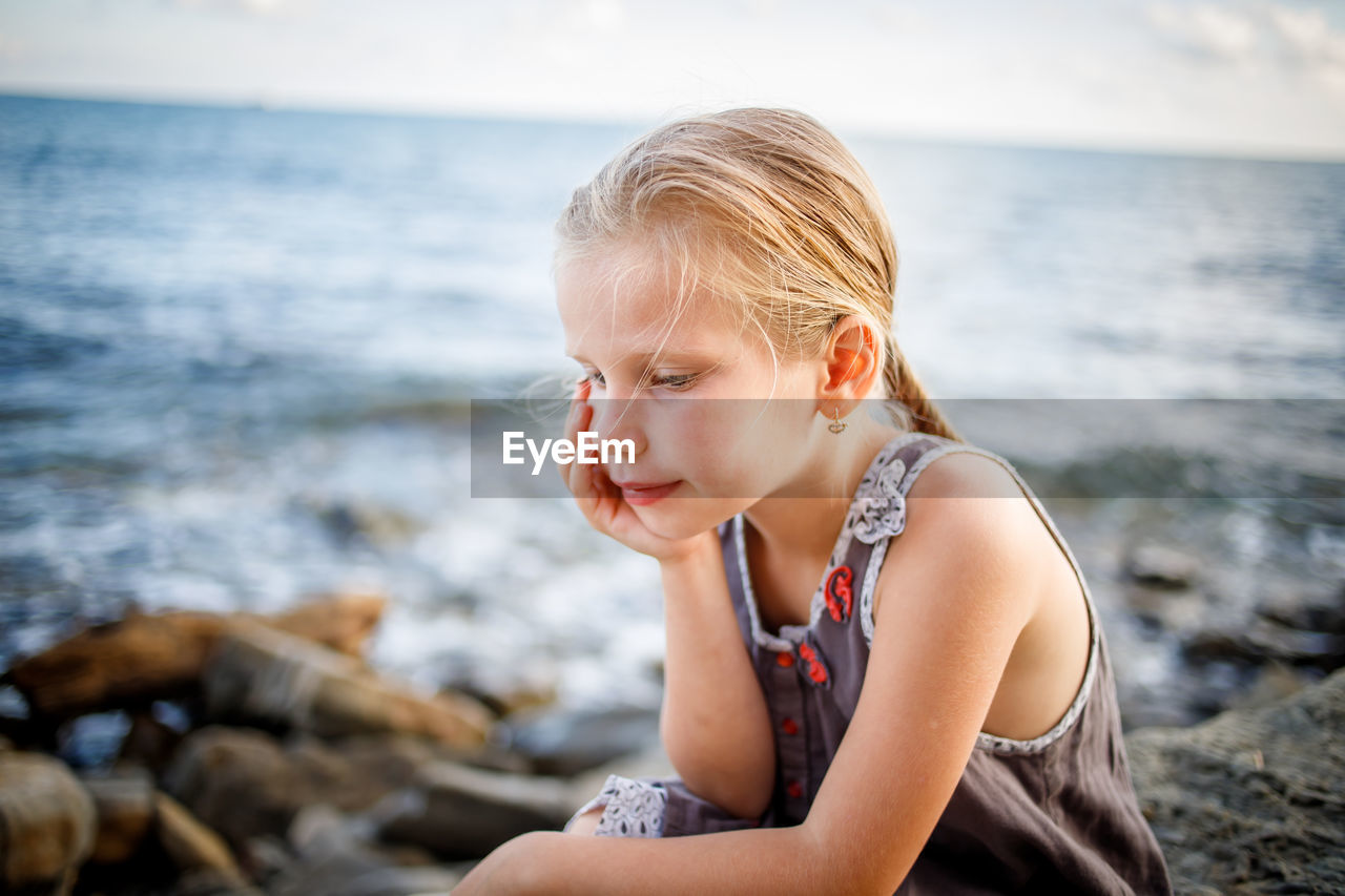 Mid adult woman sitting on beach