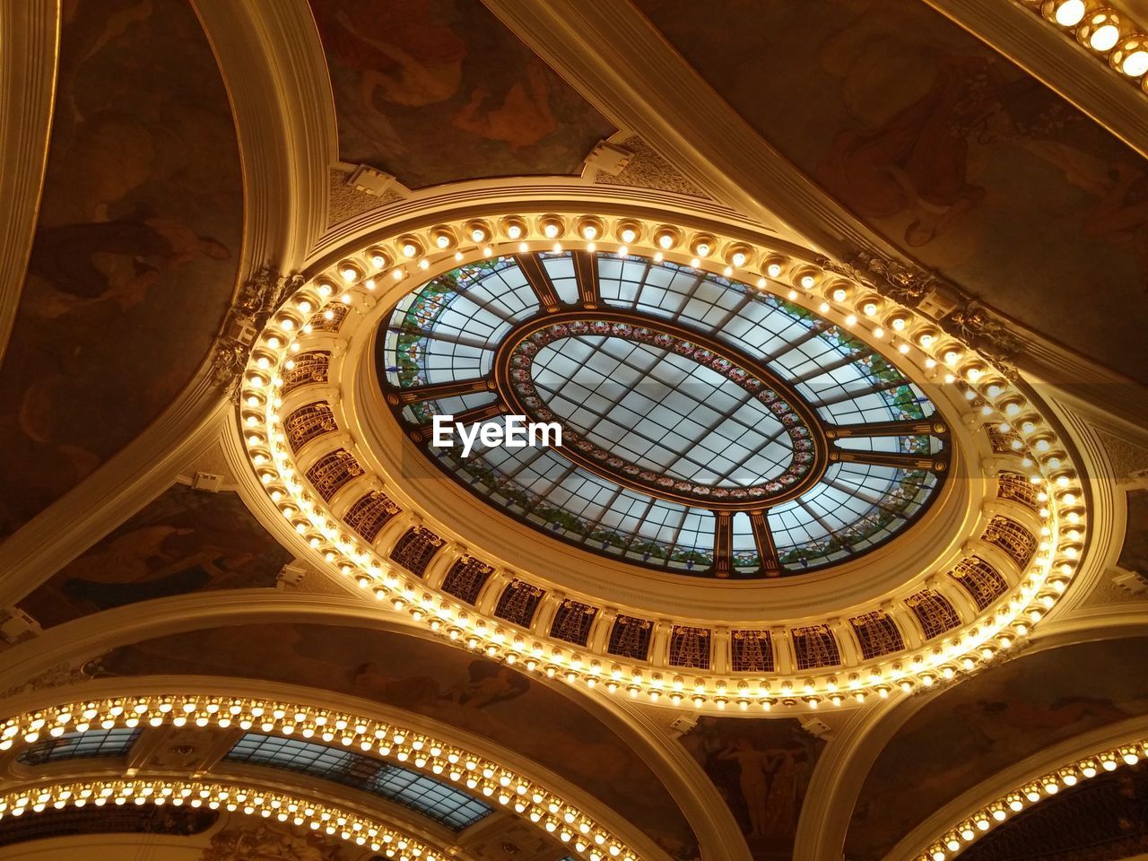 Low angle view of illuminated municipal house ceiling