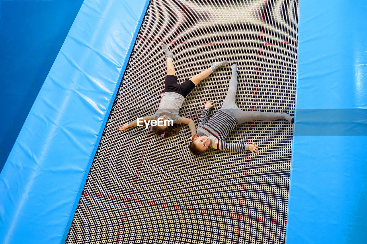 High angle view of woman lying on swimming pool