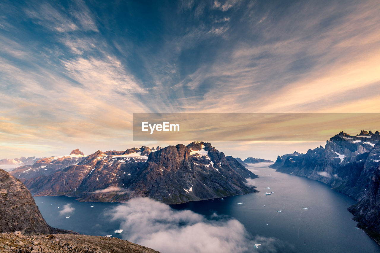 Scenic view of snowcapped mountains against sky during sunset