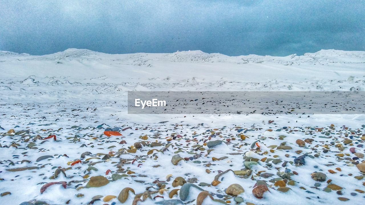 SCENIC VIEW OF LAKE AGAINST SNOW COVERED MOUNTAINS