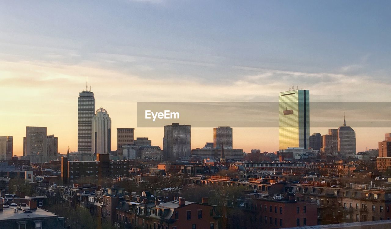 View of cityscape against cloudy sky