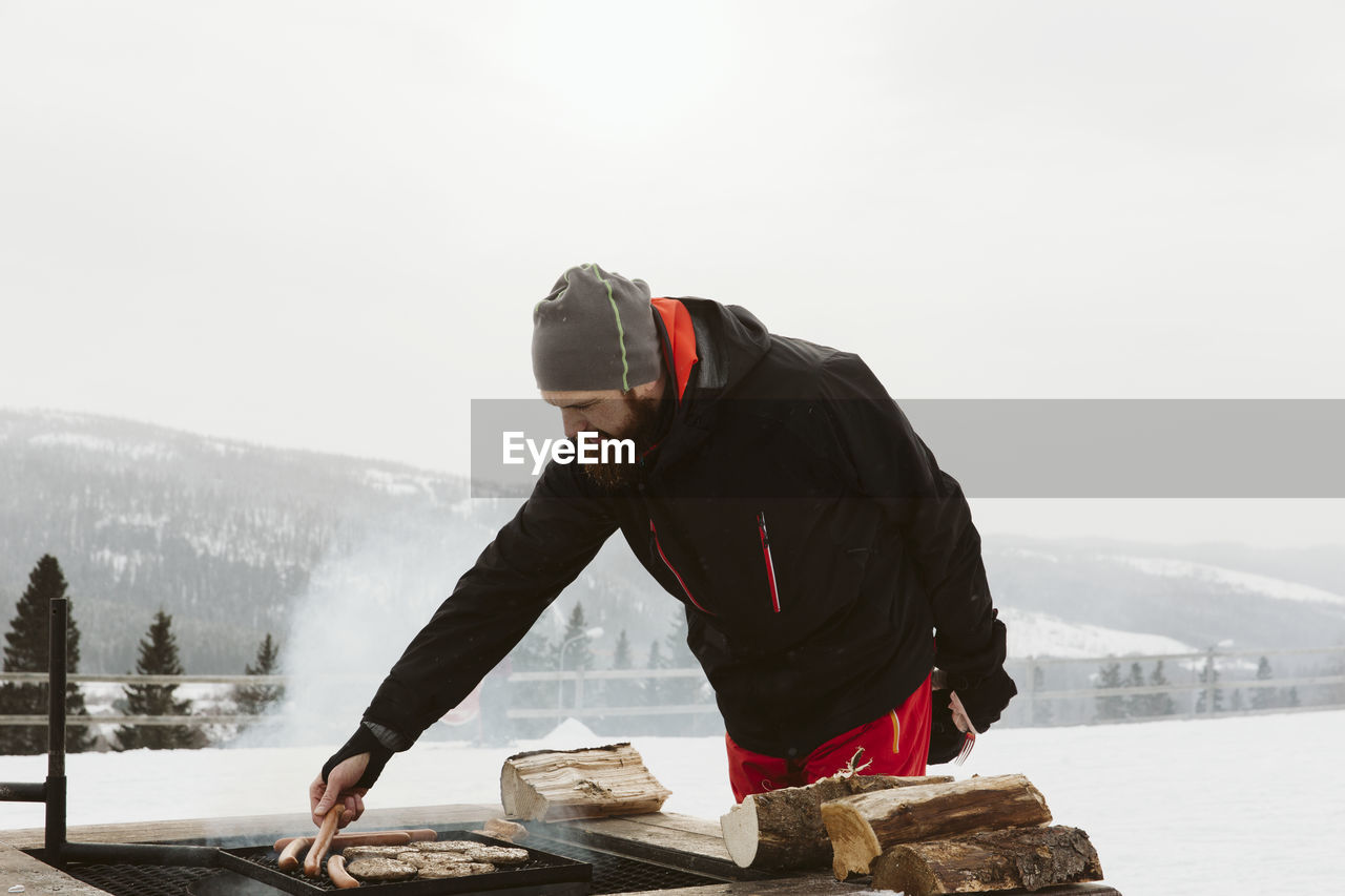 Man grilling on ski slope
